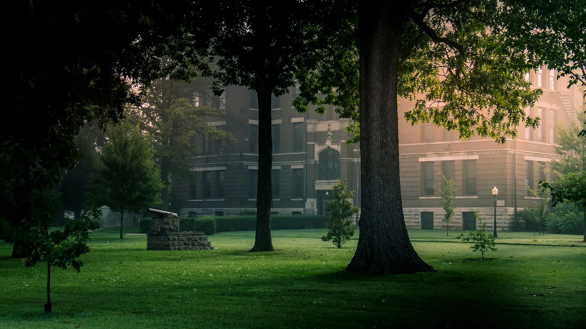 Burnham Hall at dawn through the trees on the Drury lawn